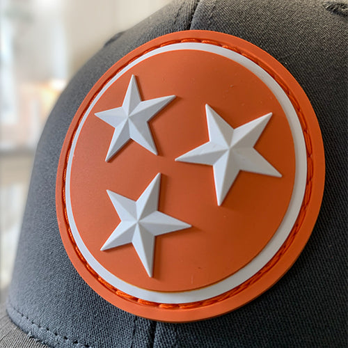 Dark navy trucker hat with orange star